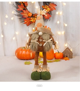 Detail of harvest gnome featuring maple leaf hat and rustic straw texture accents