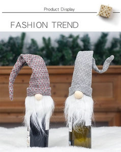 Macro detail of Nordic knit Christmas wine bottle covers with grey and red polka dot gnomes