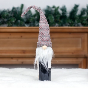 Detail of Christmas gnome wine bottle cover with grey knitted hat and white faux fur beard