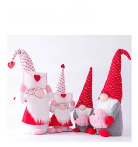 Detail of four Valentine gnomes with knitted hats and plush hearts on white background