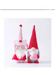 Macro shot of two Valentine gnomes featuring heart patterns and soft plush textures
