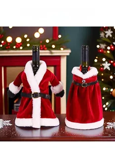 Detail of red velvet Christmas wine bottle covers in Santa suit and dress designs