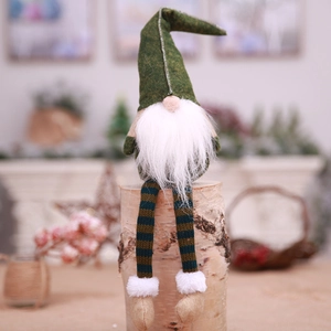 Nordic Christmas gnome plush with long legs and green hat on a wooden stand
