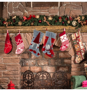 Detailed view of six Christmas gnome stockings hanging on a rustic wooden fireplace