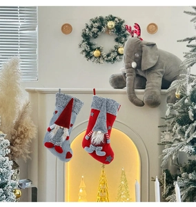 Detail of grey and red Christmas gnome stockings hanging on a fireplace mantel