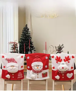 Detailed view of Santa, Snowman, and Reindeer knit chair covers in a Christmas home setting