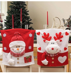 Close-up of knit Christmas chair covers with 3D reindeer and snowman designs