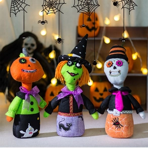 Close-up of Halloween plush doll set featuring pumpkin, witch, and skeleton characters