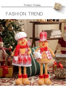 Detail of gingerbread chef couple figurines with chef hat and checkered apron decor