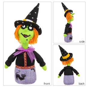 Three-angle views of a green-faced witch doll with orange hair and a black cat embroidery