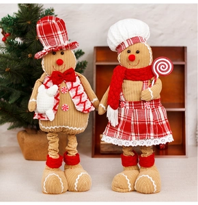 Close-up of Christmas gingerbread plush dolls in corduroy with retractable legs