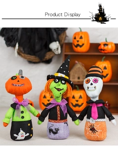 Detailed view of Halloween fabric dolls including pumpkin, witch, and skeleton characters