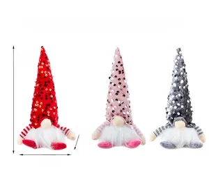 Close-up of sequined Christmas gnomes in red, pink and grey with white faux fur beard