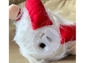 Detail of the bottom battery compartment and power switch on the glowing gnome ornament