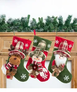Rustic Christmas stockings with reindeer, snowman and Santa Claus characters on a wooden frame