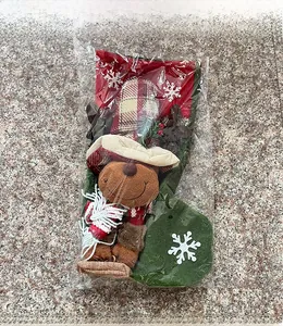 Detail view of a Christmas stocking gift bag with a 3D reindeer doll in plastic packaging