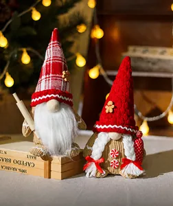 Detail of gingerbread themed faceless gnome dolls with cozy warm Christmas lights background