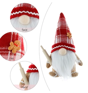 Detail of Christmas gnome with gingerbread hat accessory and wooden rolling pin toy