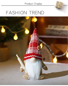 Close-up of a Christmas gnome with a red plaid hat and a wooden rolling pin