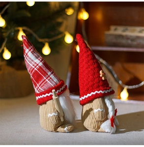 Detail of plush Christmas gnomes with gingerbread decor and a wooden rolling pin