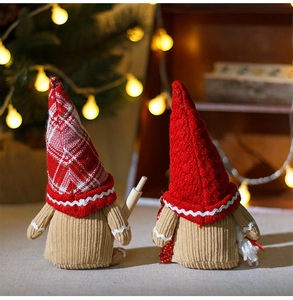 Detail of handmade Christmas gnomes featuring red checkered hats and rustic corduroy textures