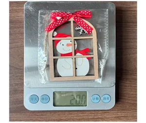 Detail showing a 20g wooden snowman ornament with red ribbon bow in protective packaging