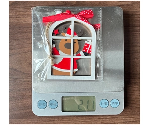 Detailed weight display of a wooden reindeer window ornament with red bow, weighing 21.1g