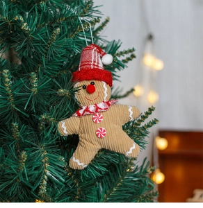 Detail of gingerbread man ornament in corduroy hanging on a Christmas tree branch
