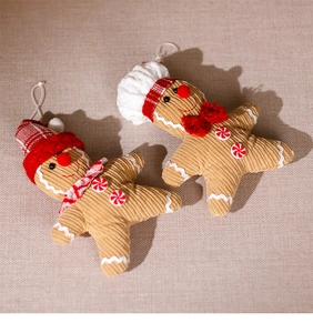 Detail of gingerbread plush ornaments with corduroy texture and festive Christmas hats