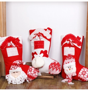 Detailed knit Christmas stockings featuring 3D Santa, Reindeer and Snowman on wooden floor