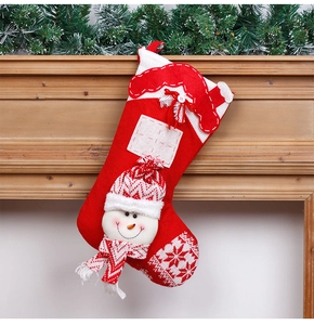 Close-up of red knitted Christmas stocking with 3D snowman hanging on fireplace