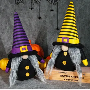 Detail of Halloween gnome dolls with striped pointed hats and orange pumpkins decor