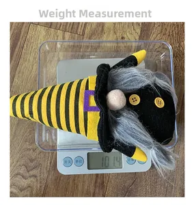 Weight measurement of a bee-themed plush gnome ornament on a digital scale