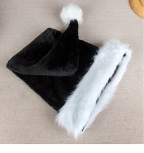 Close-up of the long black plush fabric and fluffy white faux fur trim on the hat