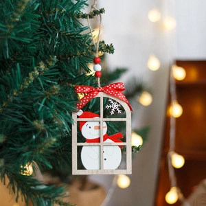 Wooden window-shaped Christmas snowman ornament with red polka dot bow on a green tree