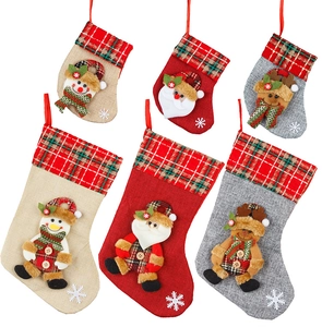 Close-up of small Christmas stockings with 3D Santa, Snowman and Reindeer characters