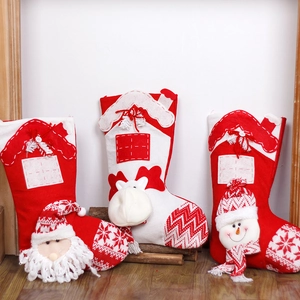 Red and white knit Christmas stockings with Santa Reindeer and Snowman patterns