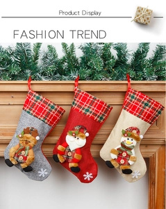 Detailed close-up of hanging burlap Christmas stockings with 3D reindeer and Santa characters