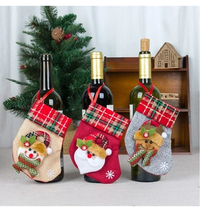Detailed view of three mini Christmas stockings used as decorative wine bottle covers