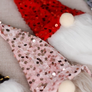 Weihnachts-Zwerg Flaschenhüllen mit Paillettenmützen und langen weißen Bärten in Rot und Rosa