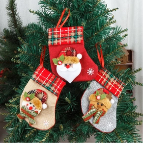 Close-up of Santa, Snowman and Reindeer 3D embroidery on rustic Christmas stockings