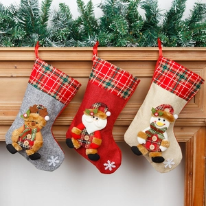 Set of 3 rustic Christmas stockings with Santa, snowman and reindeer hanging on mantel