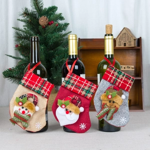 Three Christmas stocking wine bottle covers with Santa, snowman and elk patterns