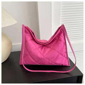 Detailed view of pink quilted rhombus pattern and padded texture on stylish tote bag