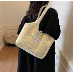 Close-up of multicolor fuzzy knit tote bag with brand label and metallic buckle detail