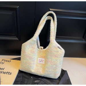 Close-up of multicolor plush tote bag featuring soft knit texture and magnetic snap closure