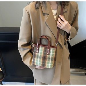 Plaid checkered handbag with brown leather strap styled on a khaki blazer jacket
