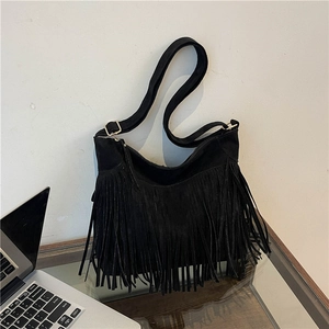 Chic black fringe shoulder bag with matte finish and bohemian tassel details