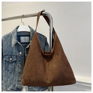 Gros plan sur le sac hobo en simili daim marron foncé avec une large bandoulière souple