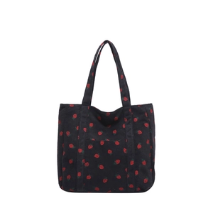 Black corduroy tote bag with strawberry print and front pocket for casual daily use